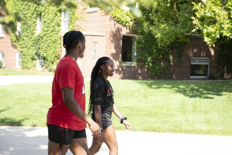 2 students walking outside