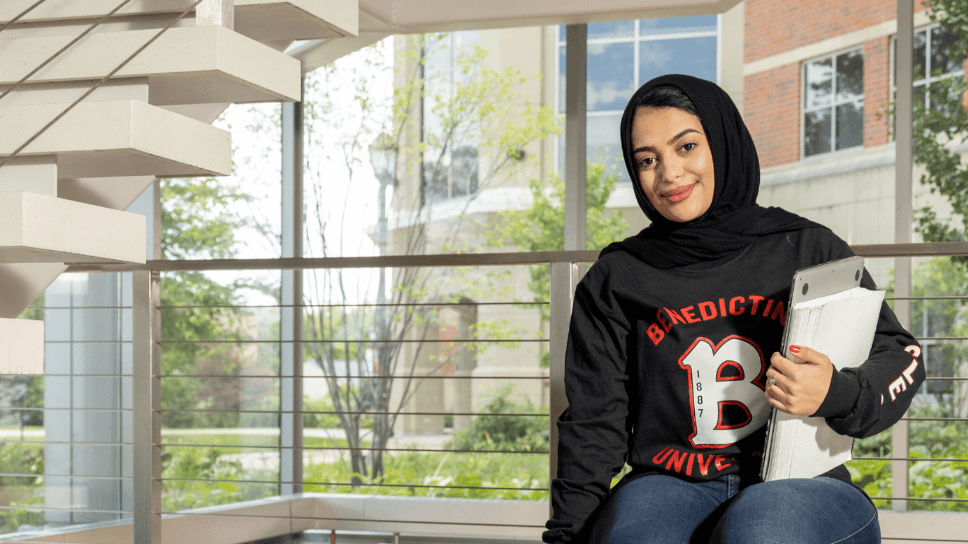 female student sitting on bench in Goodwin Hall