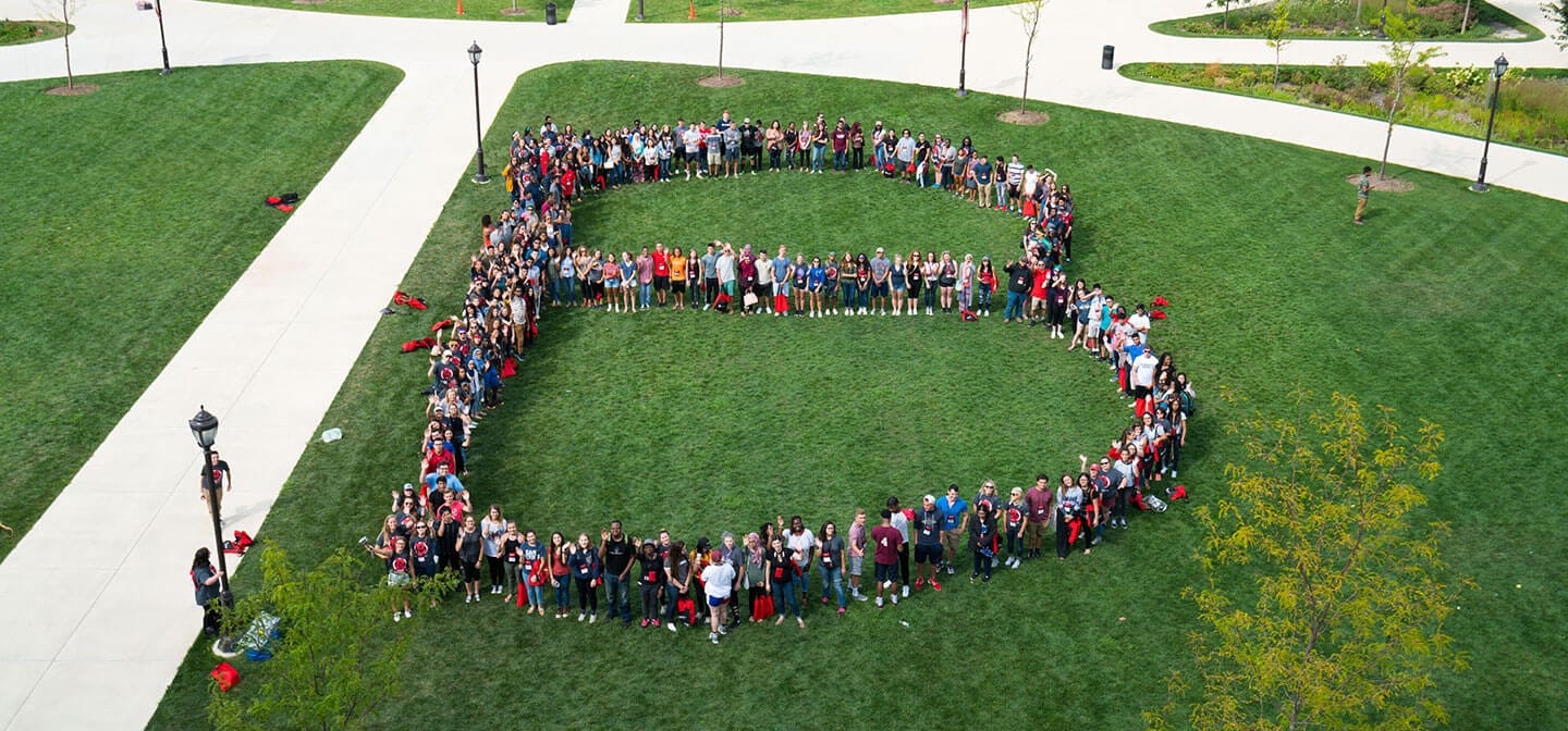 Students forming the Benedictine B on the Lisle quad