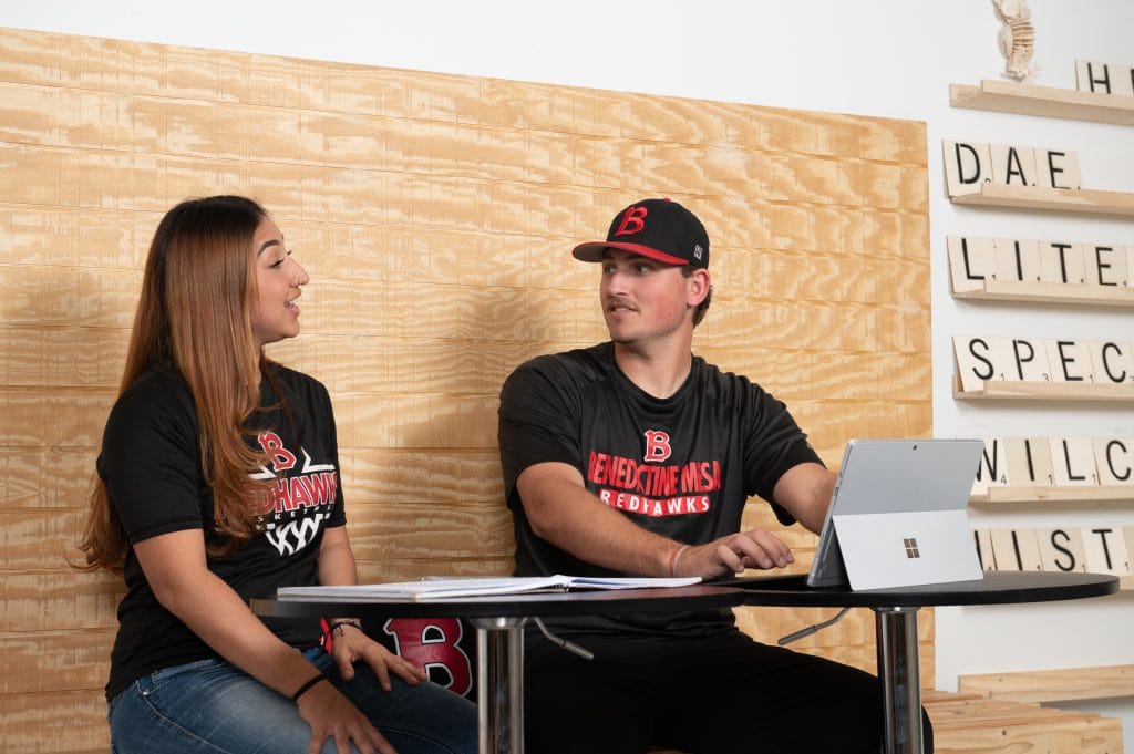 Mesa students - man and woman talking at a table