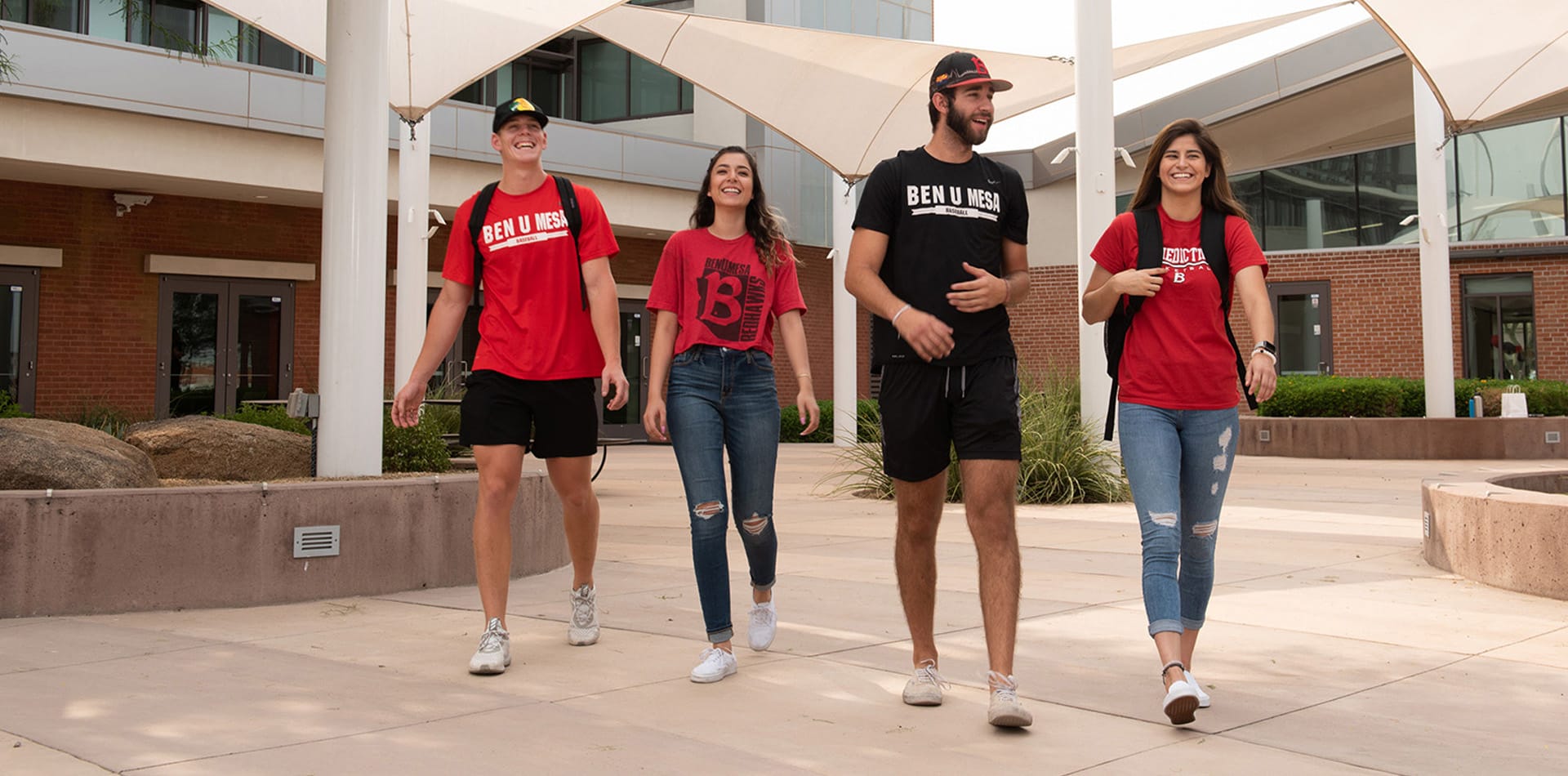 Four Mesa students walking away from Gillett Hall in Mesa