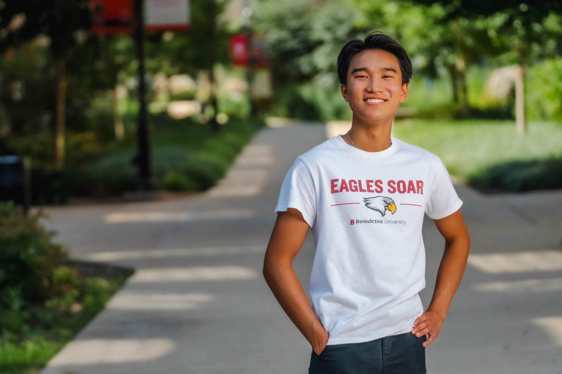 male student smiling, standing on quad, Alvic