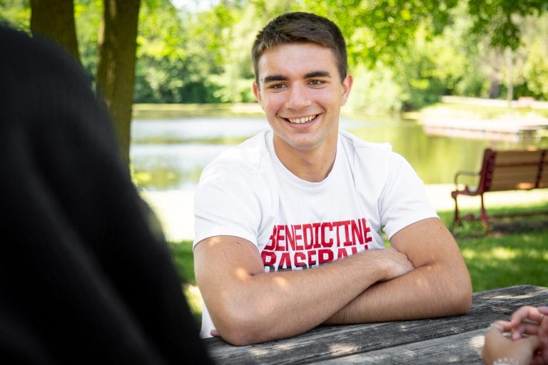 A man sitting at a picnic table.
